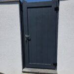 Modern dark gray aluminum driveway gate