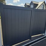Modern dark gray aluminum driveway gate